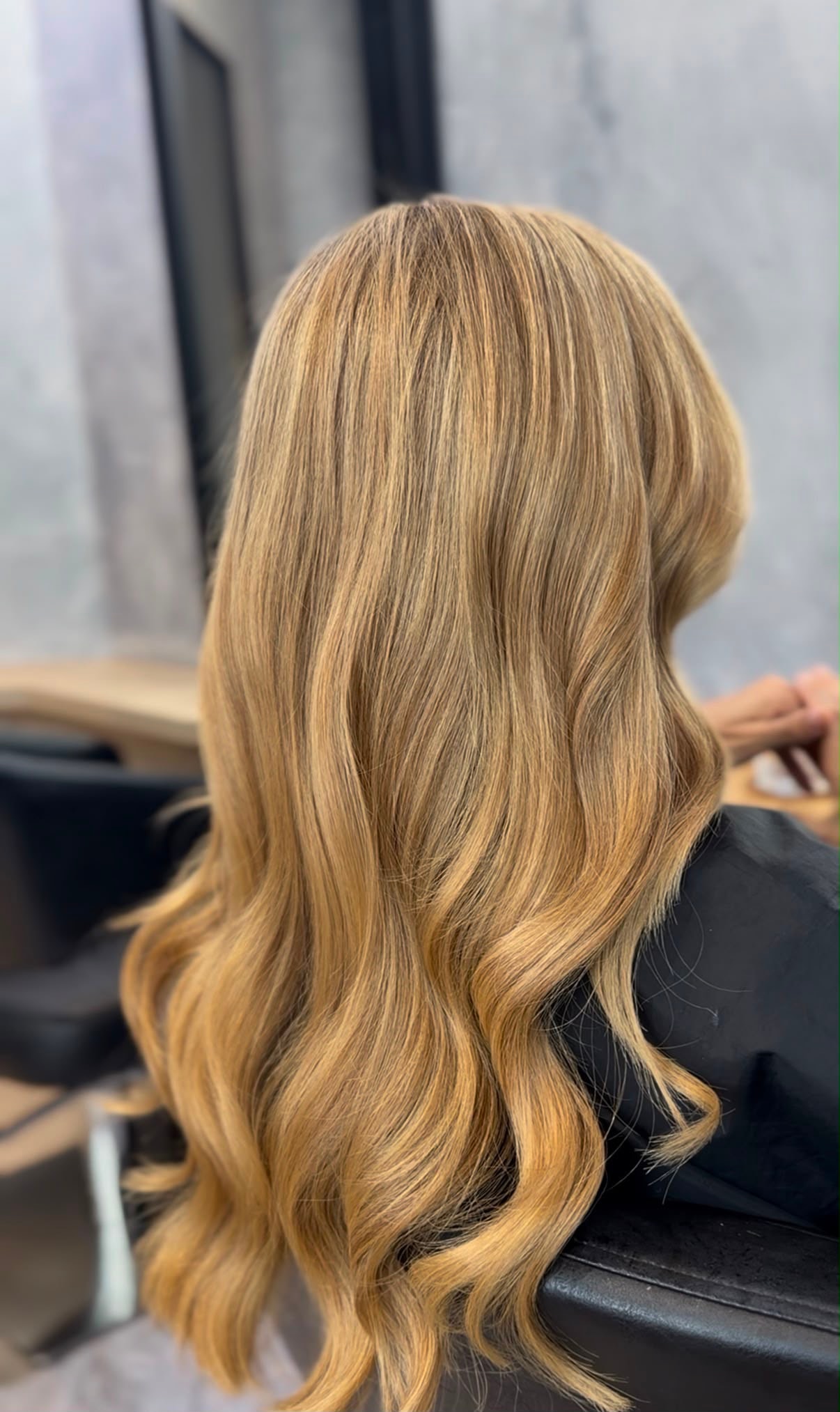 Long wavy blonde hair after balayage colour at The Sloane Salon